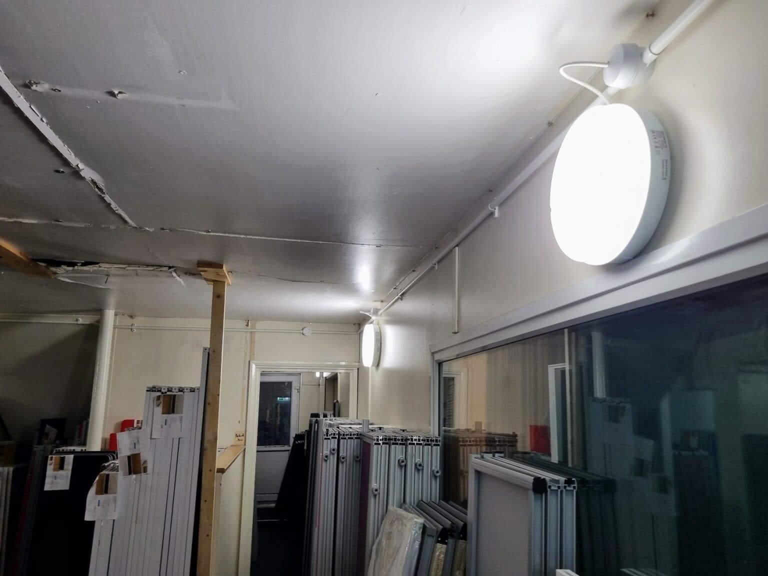 An internal storage area within ORS's Burton-on-Trent facility showing a wall-mounted LED fitting and stored stock, illustrating the operational areas RS Electrical worked around during the project.